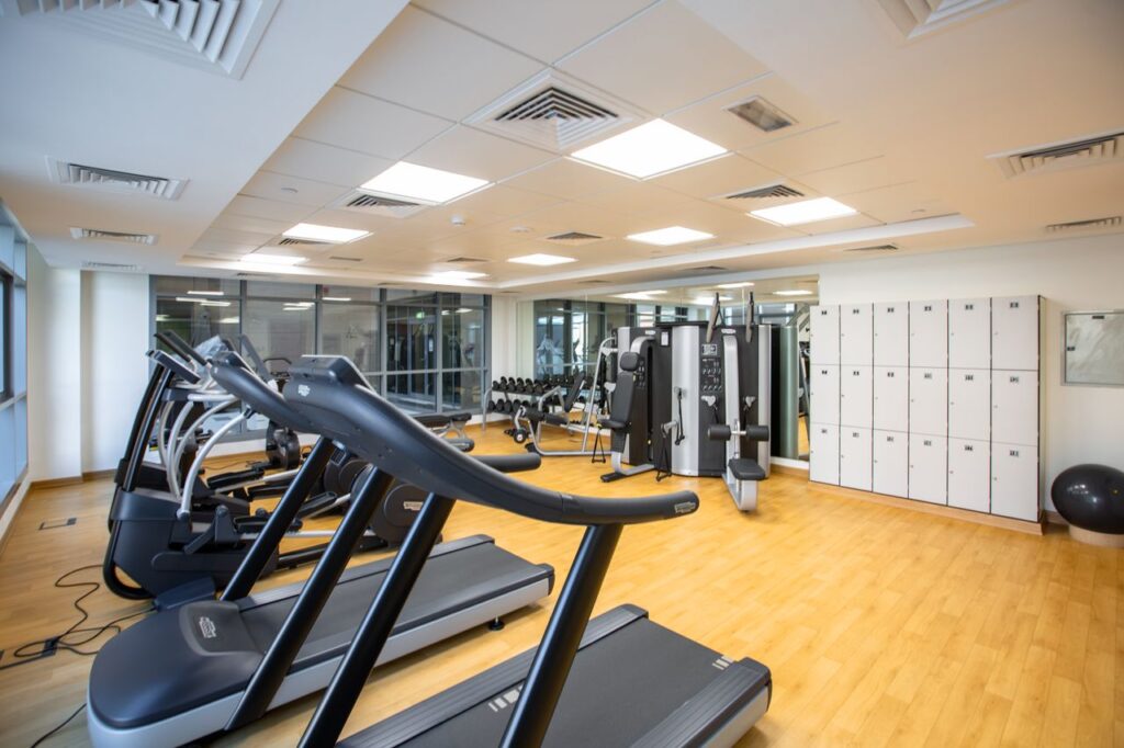 gym interior featuring treadmills, fitness machines