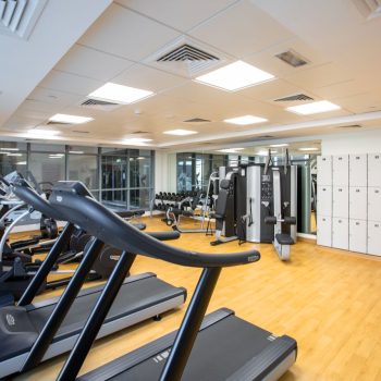 gym interior featuring treadmills, fitness machines